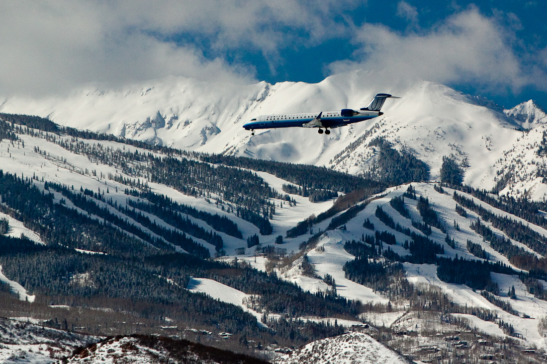 Winter plane flying into aspen